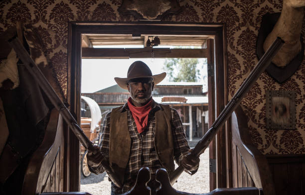istock Handsome Black Cowboy in an authentic wild west bar setting 1398621799