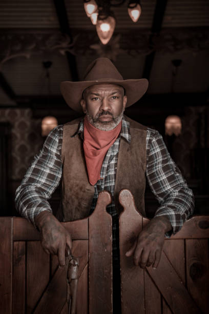 istock Handsome Black Cowboy in an authentic wild west setting 1398622047