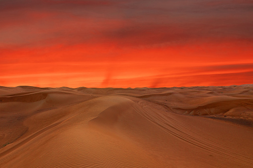 Red sunset landscape view on sand desert, Dubai, UAE