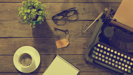 Vintage typewriter on the old wooden desk