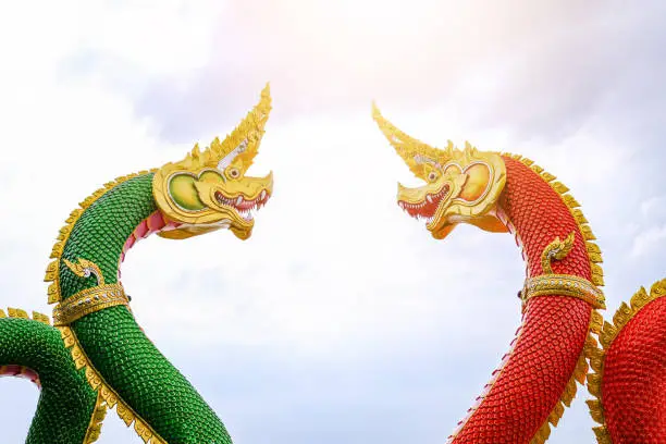 The majesty of the red and green serpent statues inside Thai temples