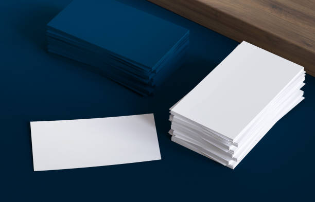 istock Blank business cards on dark background and wood table 1398627768