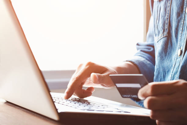 istock Young man use credit card for shopping payment online on laptop computer application or website. E-commerce and online shopping concept. 1398628901