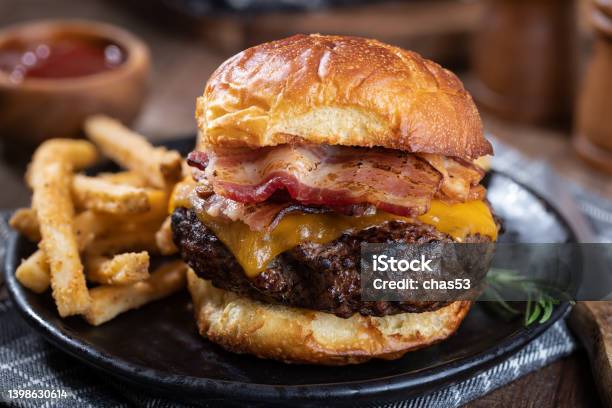 Bacon Cheeseburger On A Toasted Bun Stock Photo - Download Image Now - Burger, Hamburger, Bacon