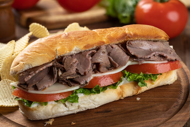 istock Submarine sandwich with roast beef, cheese, tomato and lettuce 1398630617