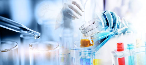 hand of scientist holding flask with lab glassware in chemical laboratory background stock photo