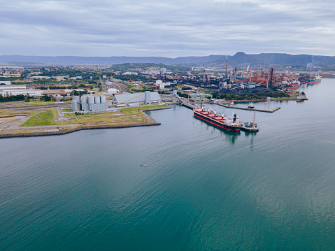 Aerial drone view of Port Kembla, in the Illawarra Region of NSW, showing the seaport, industrial complex and small harbour foreshore