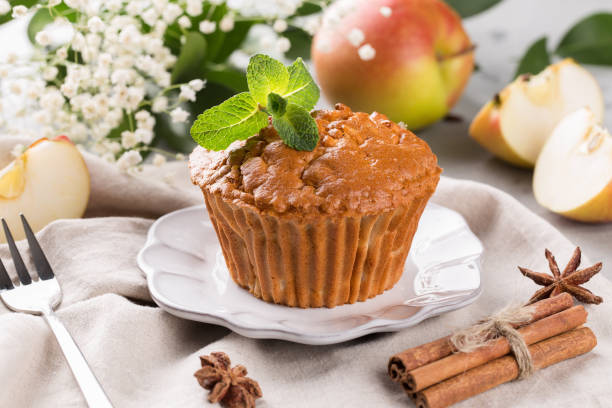 Apple muffin on a plate, decorated with fresh mint stock photo