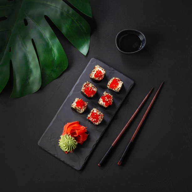istock Fresh quinoa sushi with vegetables on a stone plate - top view 1398633008