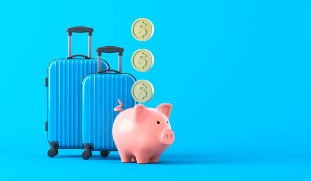 istock Pink piggy bank with a blue suitcases on blue background 1398634006