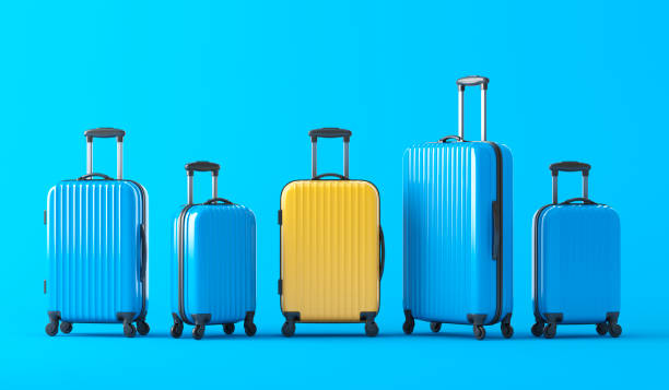 istock Yellow suitcase standing in terminal, full of blue suitcases 1398634021