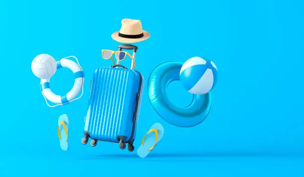 Photo of Blue Suitcase and Beach Accessories