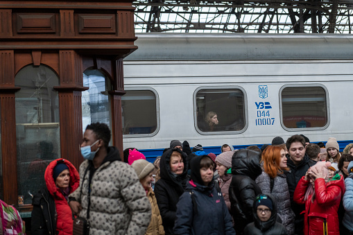 Lviv, Ukraine - February 27, 2022: A crowd of people wait for a train to Poland at the Lviv train station.