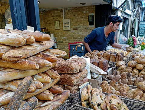 Man selling all kind of  kosher bread at his market stall in Mahane Yehuda Open market in the center on Jerusalem