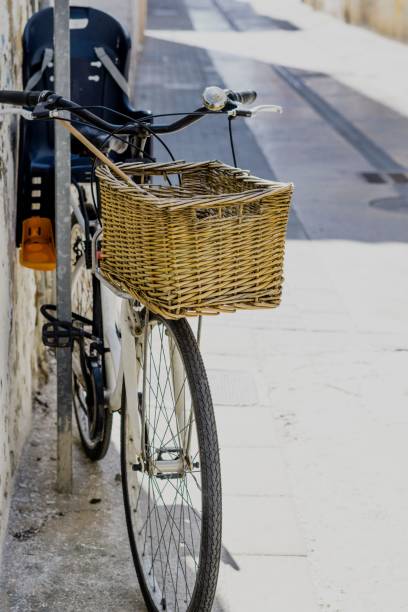 istock Vintage style bicycle with basket at the front leaning against a rustic white wall. Copy space 1398637720