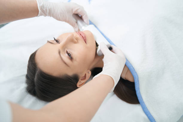 istock Microvibration Therapy device under female chin during beauty therapy 1398637771