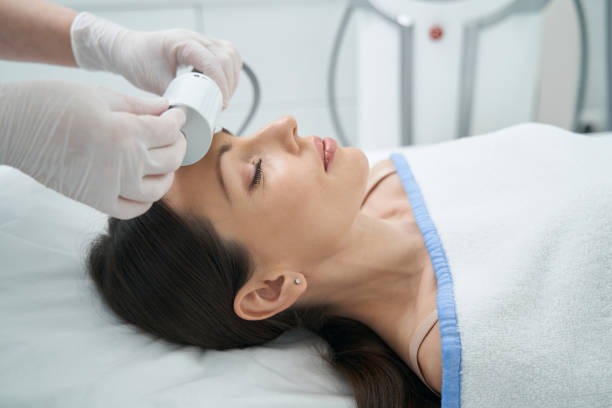 istock Resting woman in beauty parlor undergoing forehead Microvibration Therapy 1398637783
