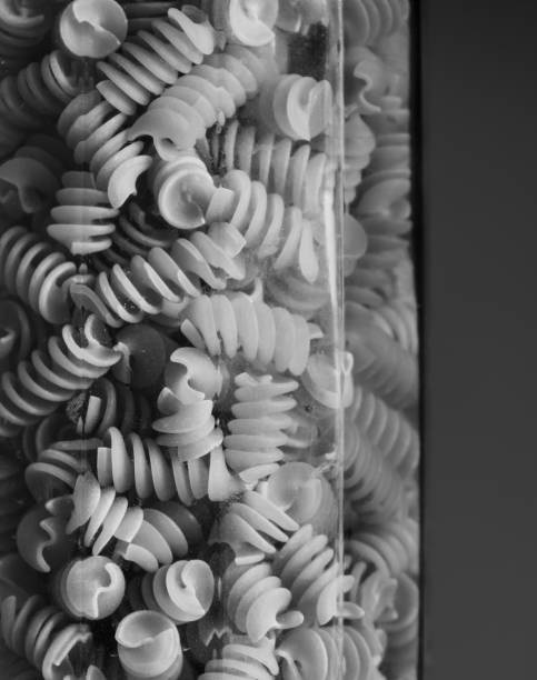 Curly pasta inside a glass jar