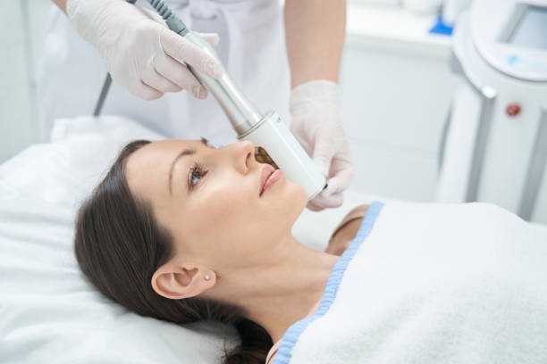 istock Female experiencing anti-wrinkle Microvibration Therapy treatment on her face 1398638720