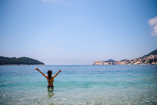 Female tourist enjoying Dubrovnik beach
