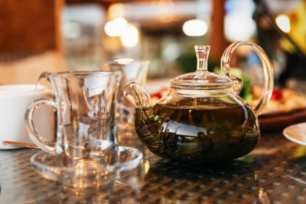 istock Green leaf tea is brewed in a teapot. 1398643323