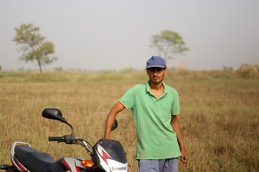 Rural farmer portrait with motorbike outdoor in nature