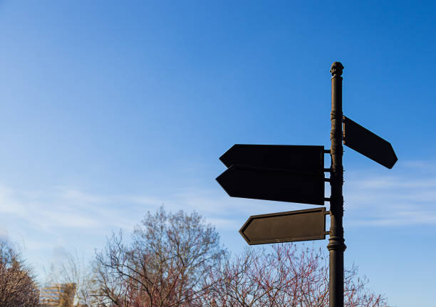 istock Large black pointer, with arrows close-up against the blue sky 1398644744