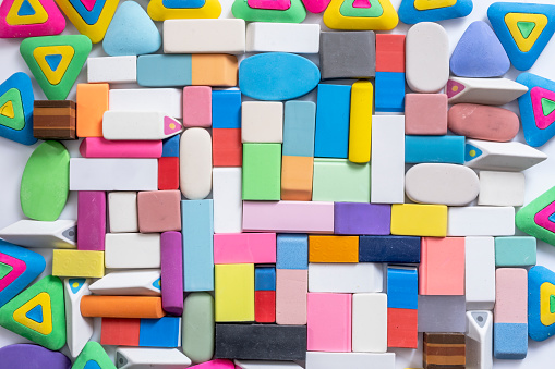 various shapes and colors of erasers arranged, top view