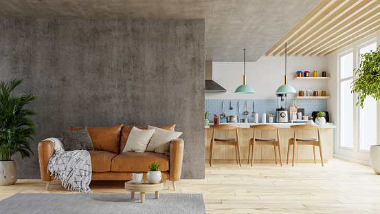 Maqueta de pared de hormigón en tonos cálidos con sofá de cuero que está detrás de la sala de la cocina. photo
