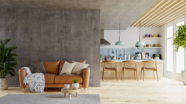 Concrete wall mock up in warm tones with leather sofa which is behind the kitchen room.