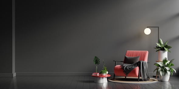 Interior wall mockup in dark tones with red armchair on black wall background.3D rendering