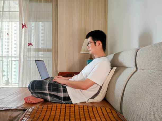 istock Asian male freelancer working at home with laptop 1398647339