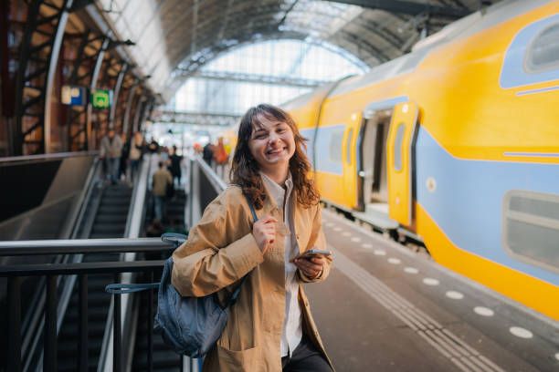 istock Woman waiting for the train on railway station 1398647487