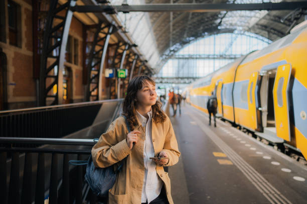 istock Woman waiting for the train on railway station 1398647510