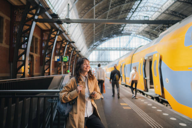 istock Woman waiting for the train on railway station 1398647584