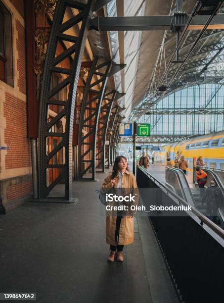 Woman Waiting For The Train On Railway Station Stock Photo - Download Image Now - Commuter, Netherlands, Adult