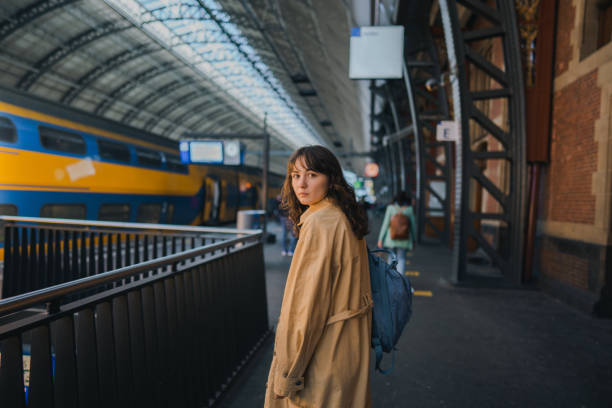 Young Caucasian woman waiting for the train on railway station