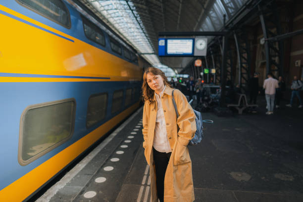 istock Woman waiting for the train on railway station 1398648608