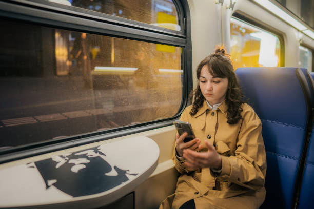 istock Woman using  smartphone while  traveling in the train 1398648976