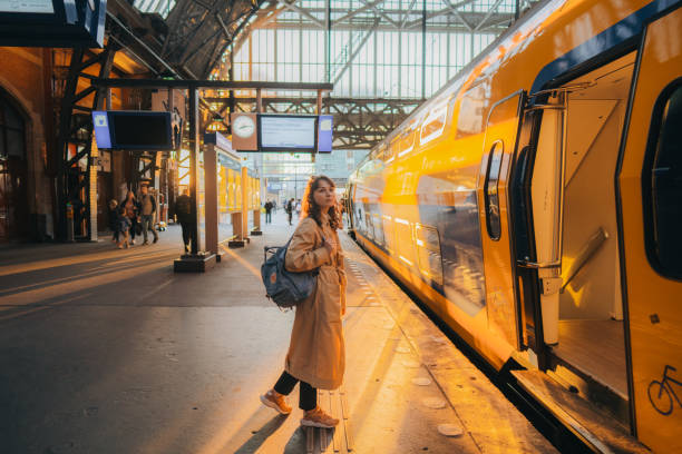 Woman waiting for the train on railway station stock photo