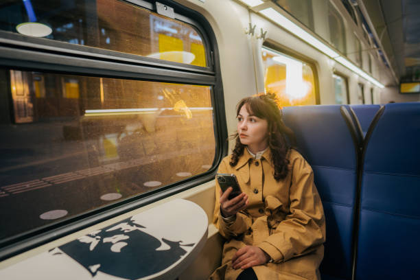 istock Woman using  smartphone while  traveling in the train 1398649107