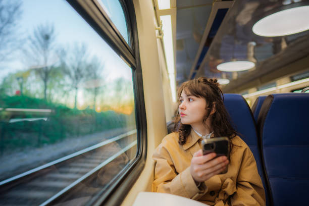 istock Woman using  smartphone while  traveling in the train 1398649288