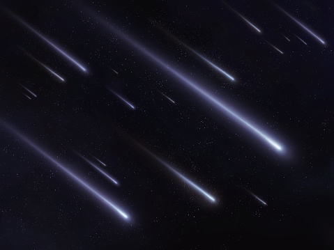 Meteor shower in the night sky. Bright meteor trails. Falling meteorites in the starry sky.