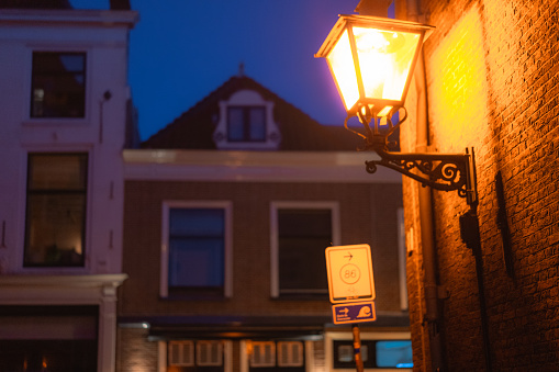 Street lamp on a brick wall at night