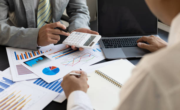 istock Two accountant discussion analysis sharing calculations about the audit company budget and financial planning together on the office desk. 1398651365