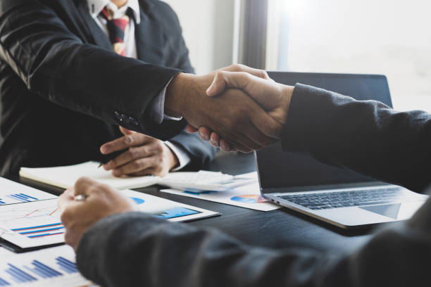 Handshake. Businessmen are agreeing on business together and shaking hands after a successful negotiation. stock photo