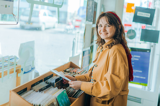 Young Caucasian woman in record store