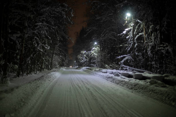 istock Road in winter. Snow-covered road in woods. 1398651897
