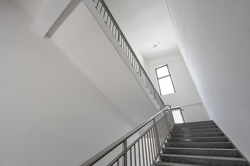 Rear view of woman walking up the steps.