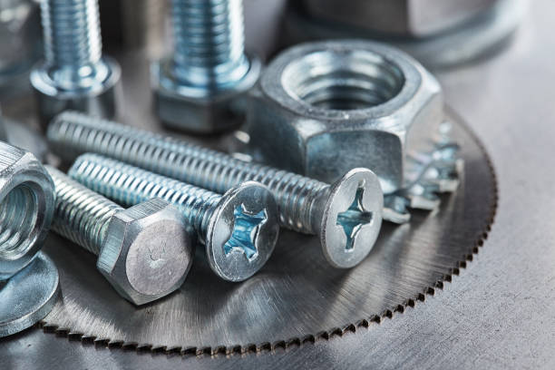 istock set of different nuts, bolts, screws, washers and drill bits,thread tap and mill cutters on steel plate background. Locksmithing deal. 1398654120